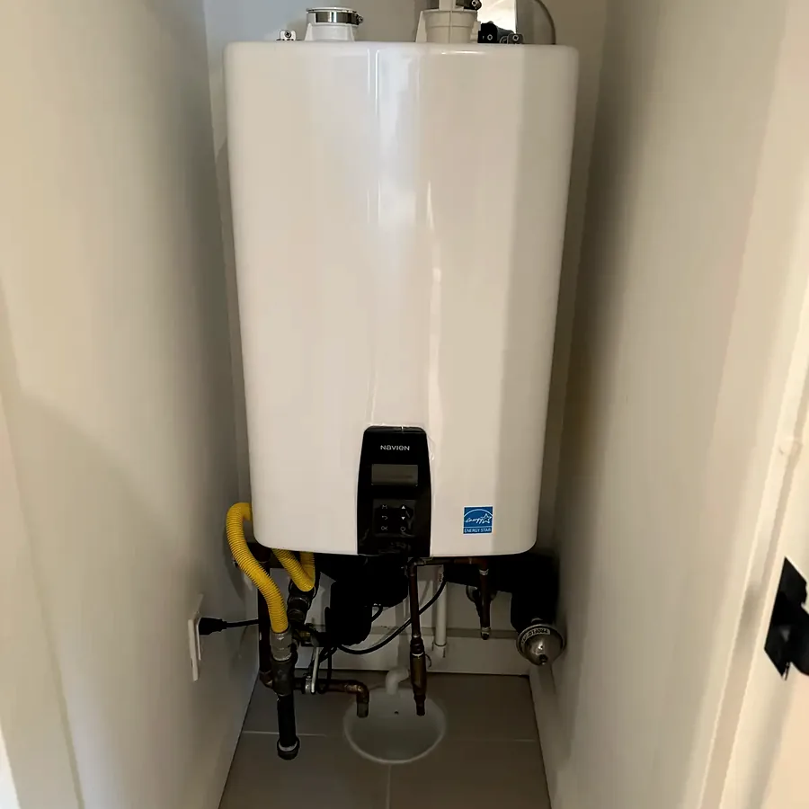 A wall-hung tankless water heater with new copper and a condensate line