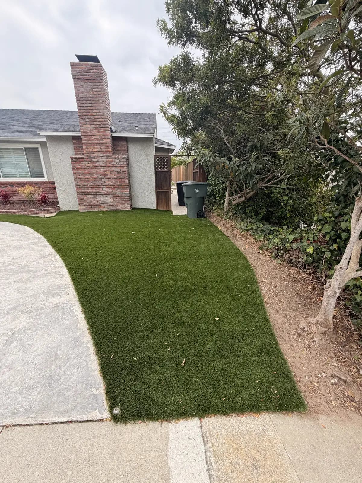 A front lawn and concrete walk intact, with no sign of digging