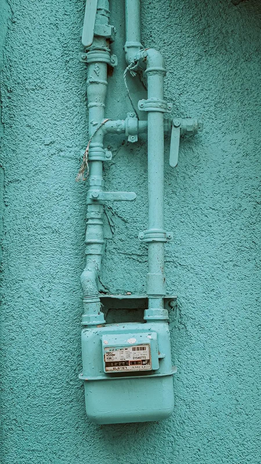 An exterior gas meter and riser piping being inspected