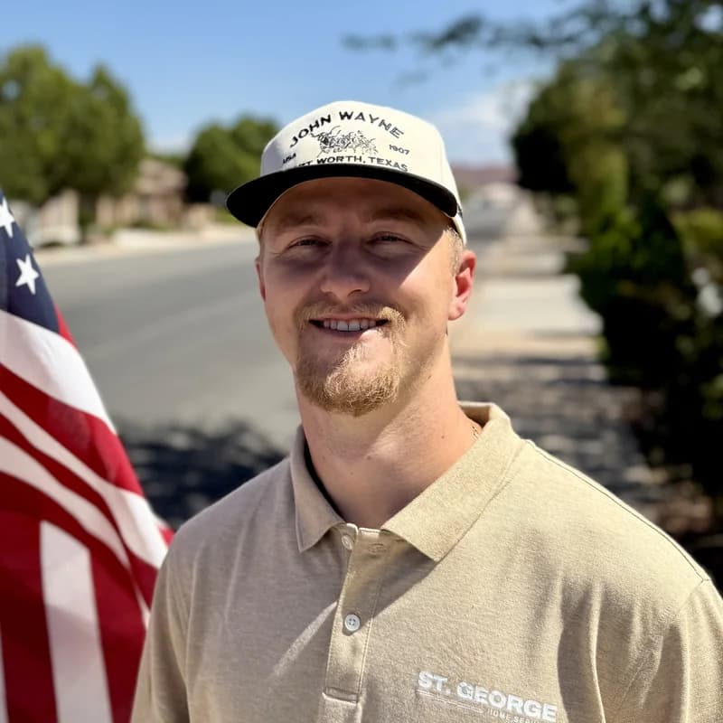 Ryan Nunez, in a company polo shirt on a street in St. George