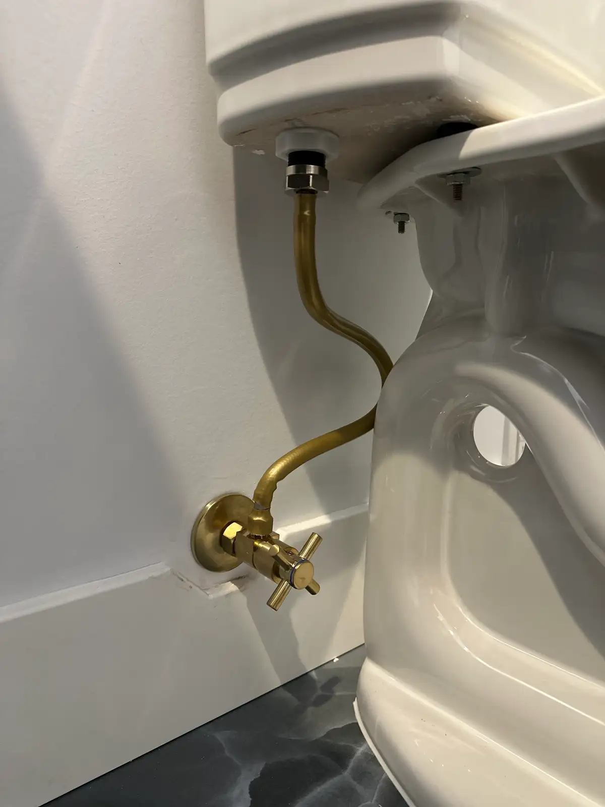 A toilet supply line and angle stop replaced with new braided line and a quarter-turn valve