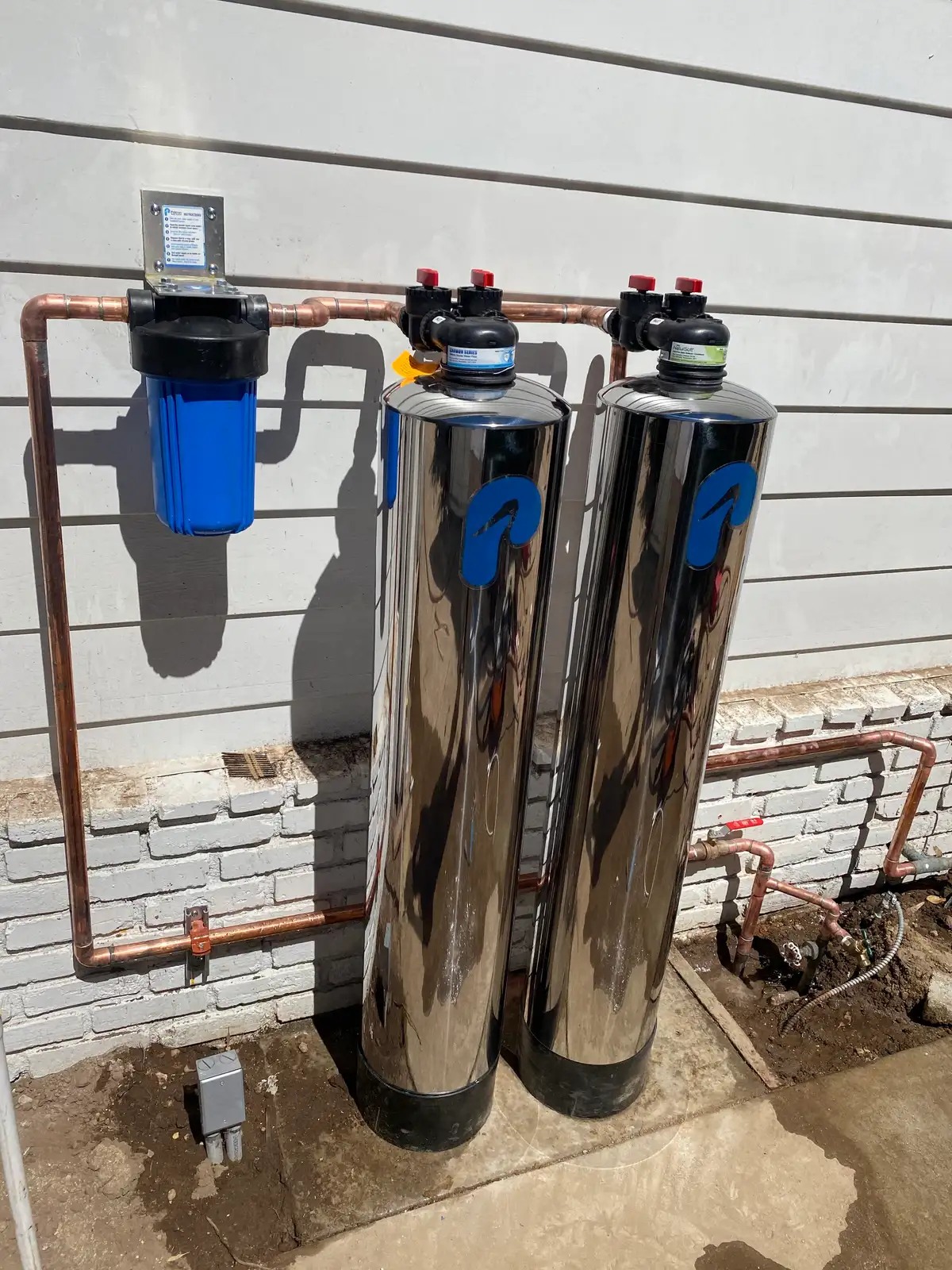 A whole-house filtration system with its bypass valves and pressure gauges plumbed in