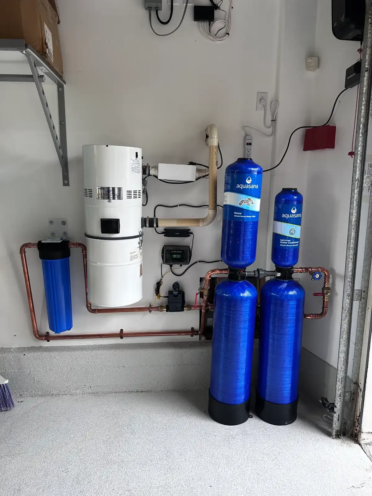 A softener and filter pair installed together with new supply piping
