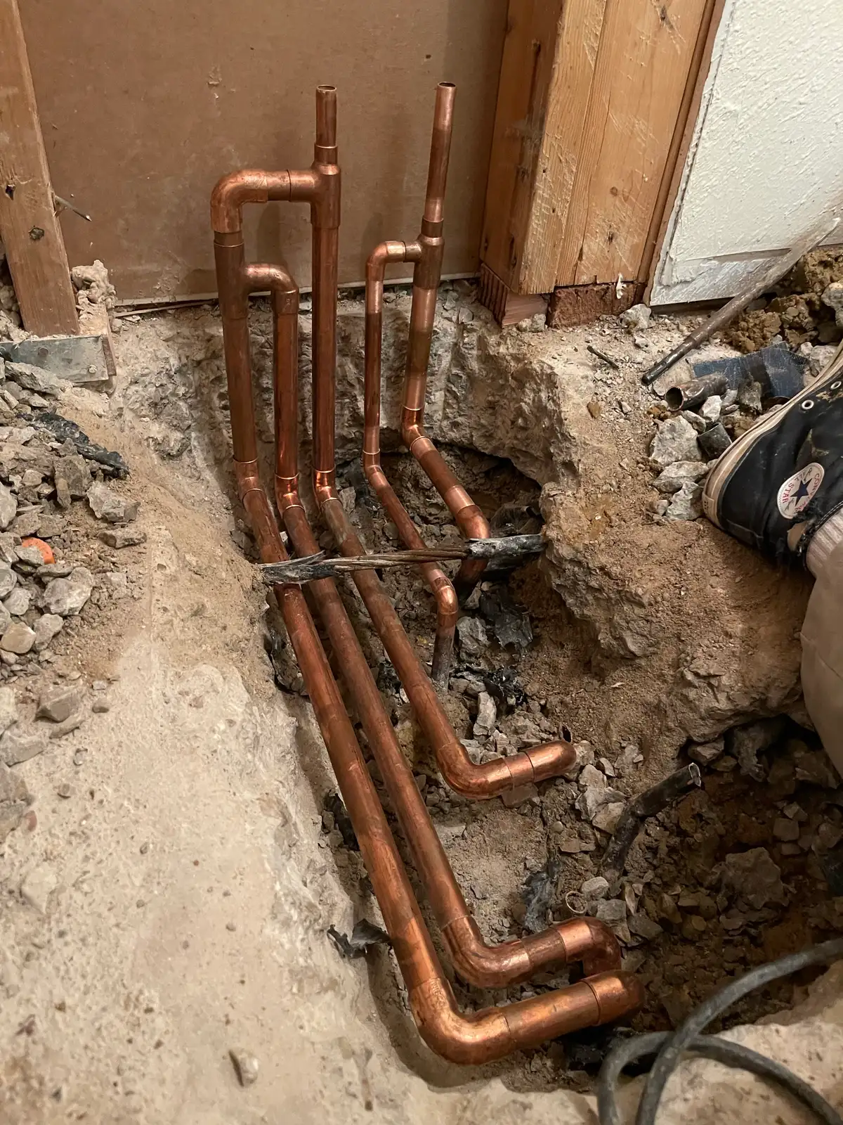 A manifold installed to reroute water lines away from a failed pipe under a slab